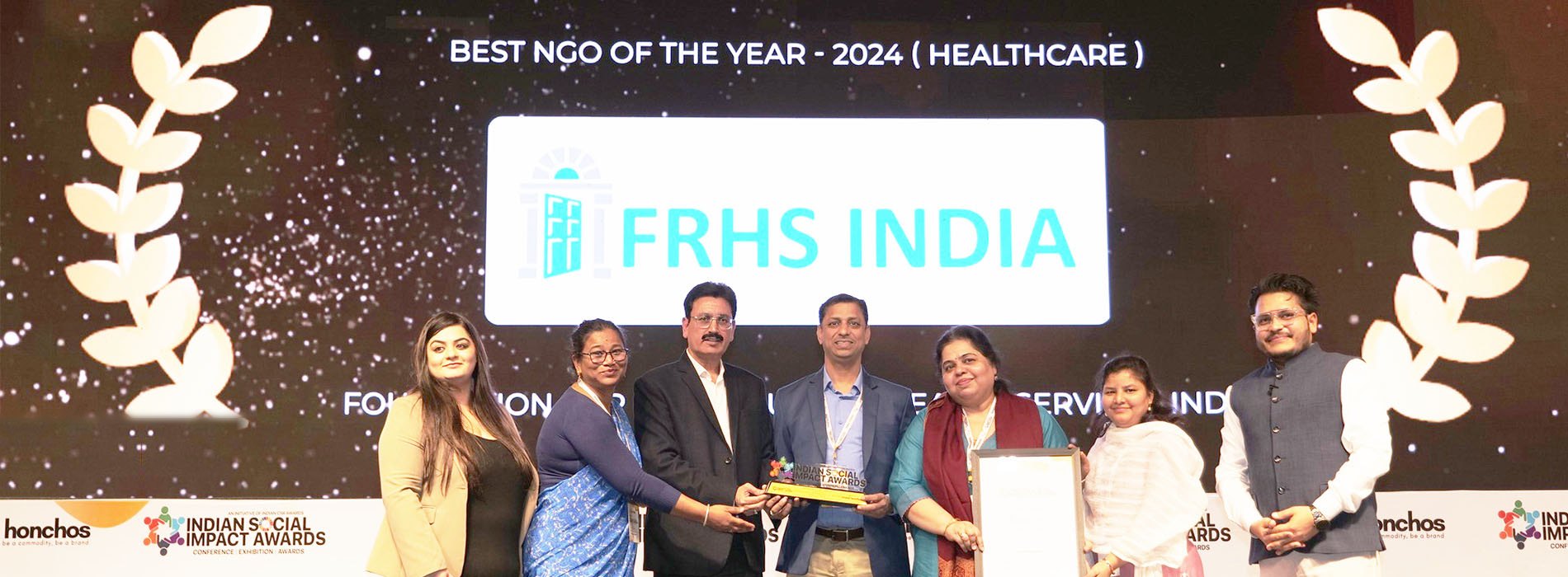 The FRHS India team receiving the Best NGO of the Year – 2024 (Healthcare) award on stage at the Indian Social Impact Awards