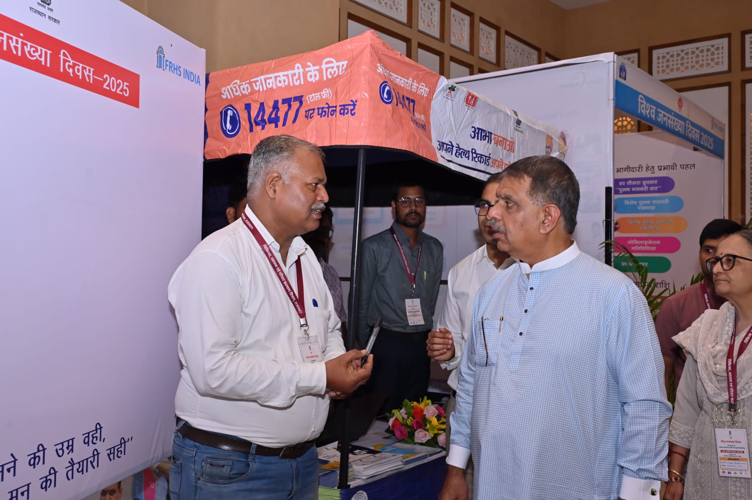 FRHS India team speaking with a Rajasthan health official at the World Population Day 2025 event