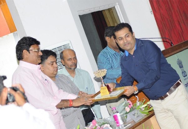 An FRHS India colleague receiving an award from district officials