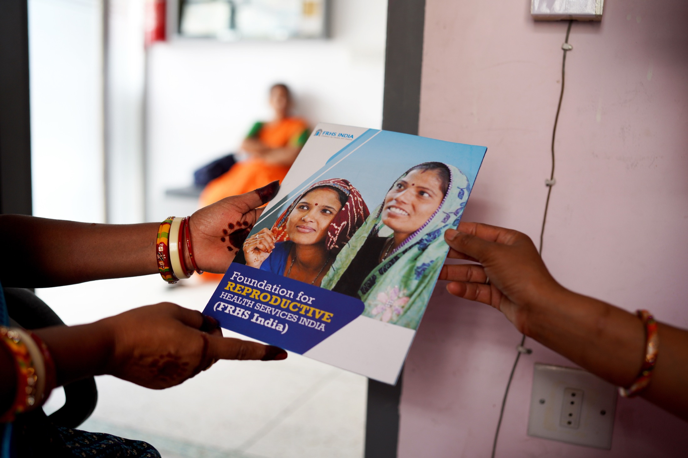 A health worker speaking with a client at an FRHS India service site