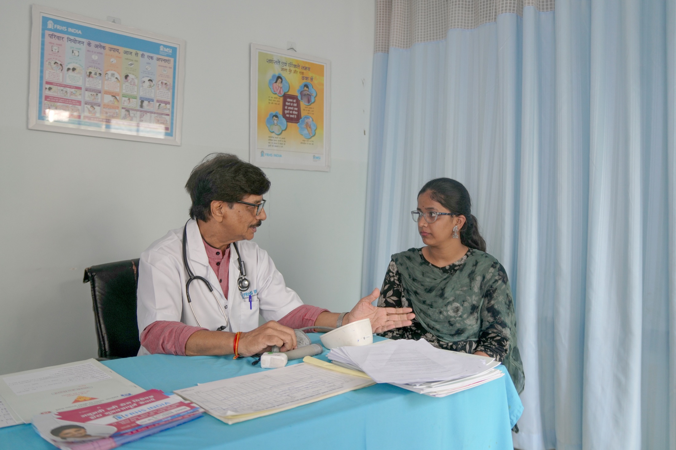 A doctor examining a client at an FRHS India clinic